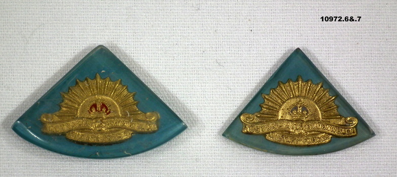 Collection of partially and fully completed badges and brooches.