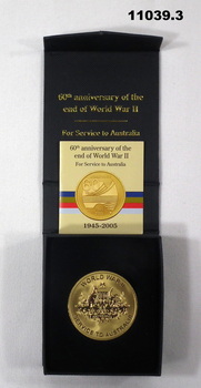 Gold coloured medal marking the 60th Anniversary of the end of WWII.