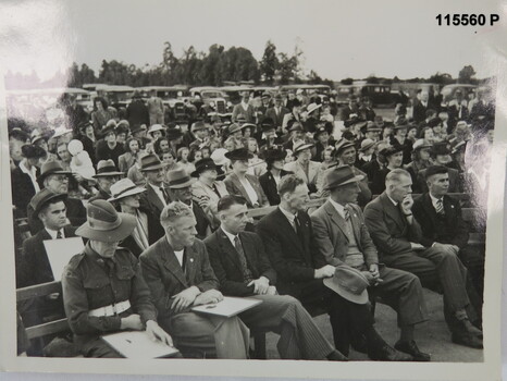 Black and white photograph of a crowd at a presentation. WW2 era.