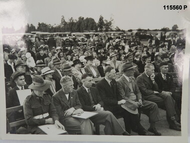 Black and white photograph of a crowd at a presentation. WW2 era.