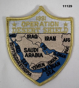 Shield shaped cloth shoulder badge featuring map of the Middle East.