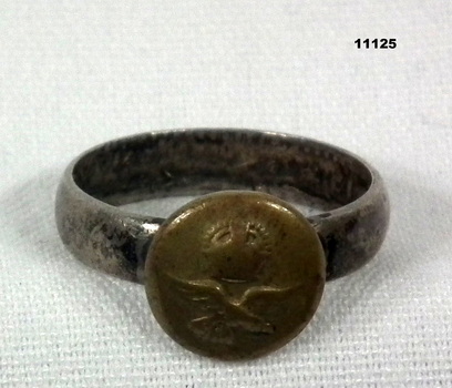 A metal Navy Signet Ring.