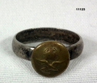 A metal Navy Signet Ring.