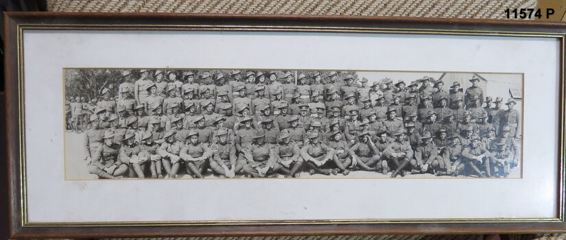 Framed photograph of 5 rows of soldiers seated and standing.