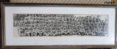 Framed photograph of 5 rows of soldiers seated and standing.