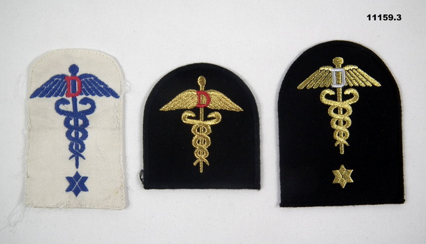 Three Naval Dental Category badges.  One summer uniform, two winter uniform.