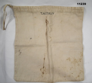 White calico bag with draw string.