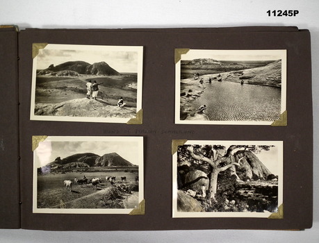 Light brown cardboard covered album with photographs.