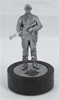 Metal miniature figurine of soldier with rifle on black cylinder base