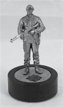 Metal miniature figurine of soldier with rifle on black cylinder base