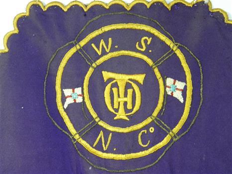 This is an embroidered monogram on a workers apron.