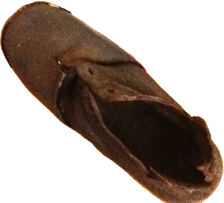 This is a small child’s brown shoe made of leather with a lace-up upper part (no laces) and a leather sole.  