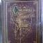 A leather bound Colonial family photo album with an ornate embossed cover.