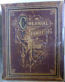 A leather bound Colonial family photo album with an ornate embossed cover.