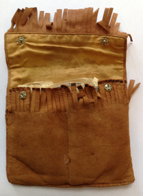 This is a tan suede pouch with fringing and which has a packaged  cello strings inside.