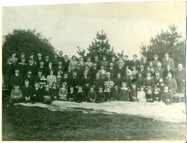 This is a black and white photograph of a large family group.