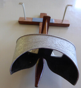 This is a wood and metal stereoscope used to view photographs.