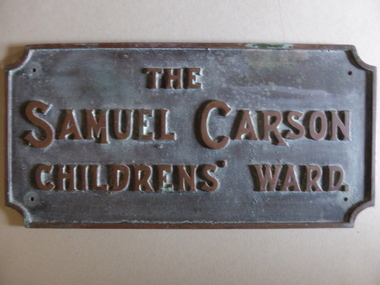 This is a rectangular brass plate with raised lettering.