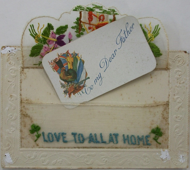 This is a postcard from WW1 which is embroidered on the front and has a small card inserted inside.