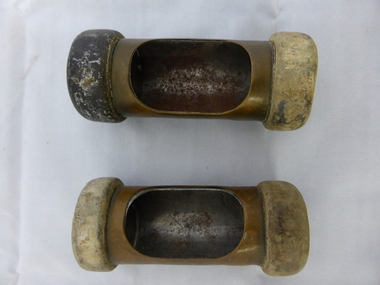 These are two brass and metal cash carriers which were used in Swinton's store to move money from sales area to office for recording.