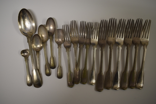 This is a collection of metal cutlery mainly forks and spoons.