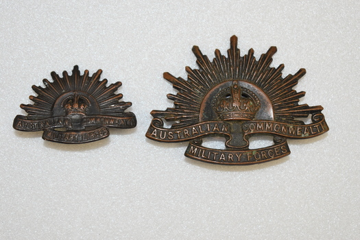 Two Rising Sun Australian army badges.