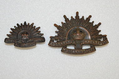 Two Rising Sun Australian army badges.
