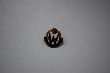 A small metal badge  produced in 1951.