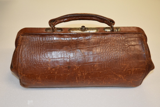 This is a brown leather gladestone bag.
