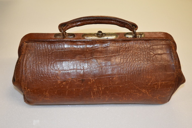 This is a brown leather gladestone bag.