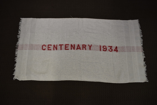 This is a white towel with red writing down the centre.