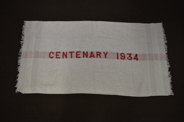This is a white towel with red writing down the centre.