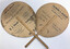 This is a handheld cardboard fan with a wooden handle.
