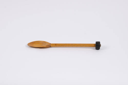 Side view of wooden spoon - the striker for the dinner gong