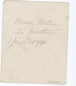 Yellowed back of old postcard with pencil inscription