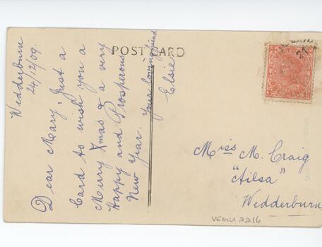 Cream postcard with ink inscription on left side, written sideways, and address and red stamp on the right side. 