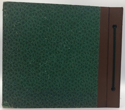 Back cover of album. Dark green with brown binder threaded with green cord.