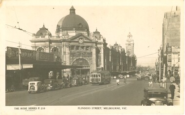 A yellowed black and white postcard depicting Flinders Street Station.