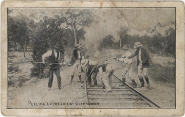 Postcard depicting three men with guns and one with a long pole threatening two men with tools on a railway line.