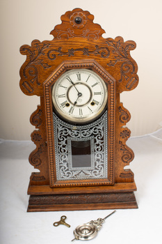 front of mantle clock with key and pendulum