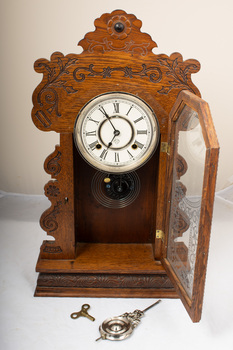 mantle clock with door open and key and pendulum 