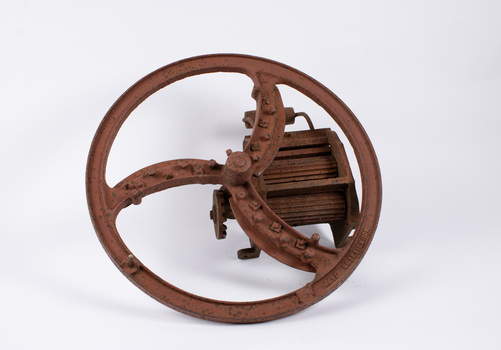 Front view of small chaff cutter with manufacturer inscription visible on wheel