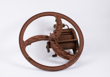 Front view of small chaff cutter with manufacturer inscription visible on wheel