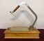 Cheese slicer on wooden base with raised arm showing cutting wire