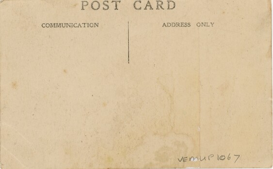 Back of a of post card of children on a street in a Welsh village