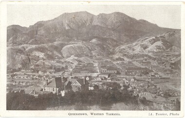 Scenic view of Queenstown, Tasmania showing large and small buildings and houses with Mt Owen in the background.