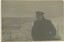 Black and white photograph of Winston Churchill aboard navy boat with ocean in background.