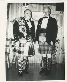 Black and white photograph depicting Dr Murphy and his friend Tom Dalziel dressed in highland regalia c1960s.
