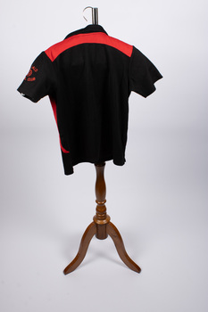 Back view of netball uniform top - black and red colors