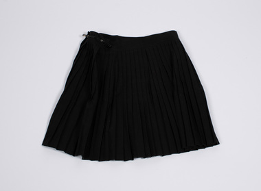 Front view of black netball skirt laid flat